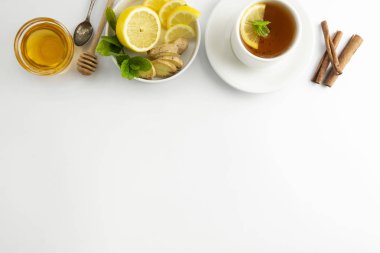 Fresh tea with lemon and honey on a white background. Hot tea cup isolated, top view flat lay. Flat lay. Autumn, fall or winter drink. Copy space. clipart