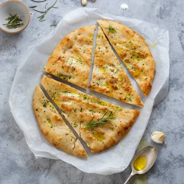 Garlic foccacia bread. Freshly baked flat garlic bread, olive oil and herbs.