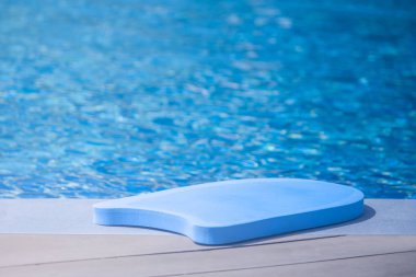 Renkli yüzme yakın köpük çocuklar için yüzme havuzu kenarında koyun kurulu. (Seçici odak)