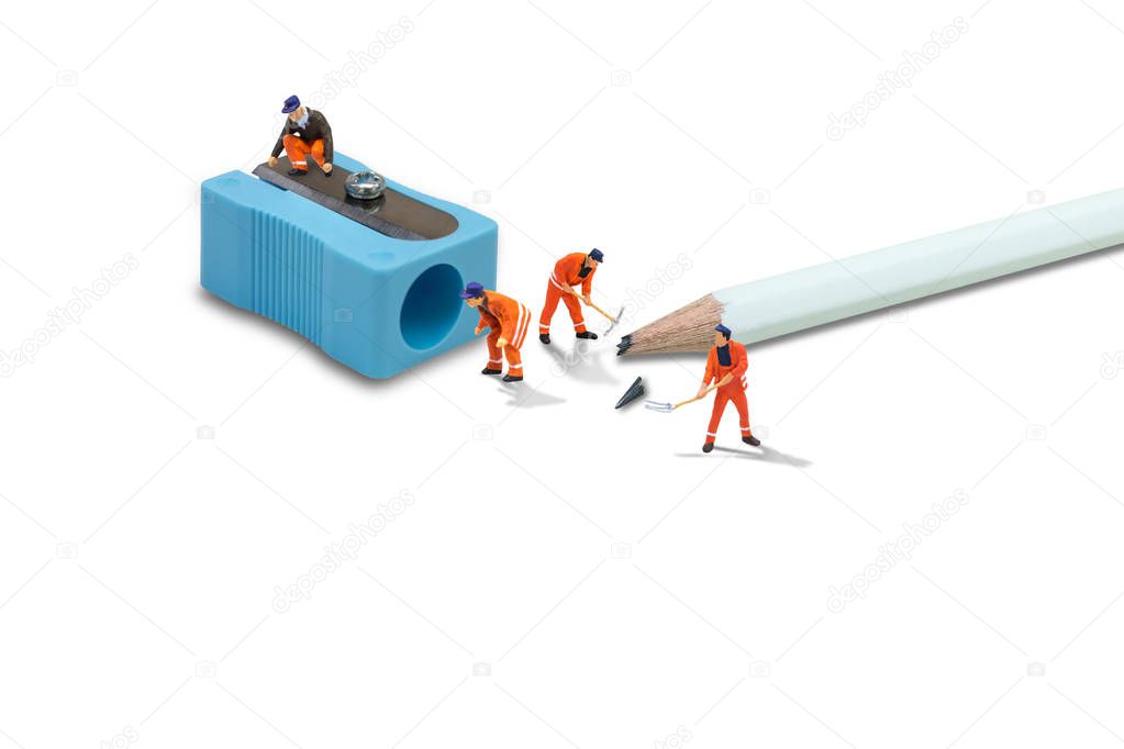 Business Idea Concept : Miniature figurine character as construction worker repairman working check and repair sharpener pencil damaged.