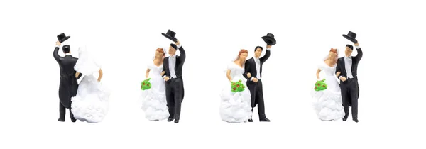 Miniature figurine character as Bride and Groom posing in posture isolated on white background.