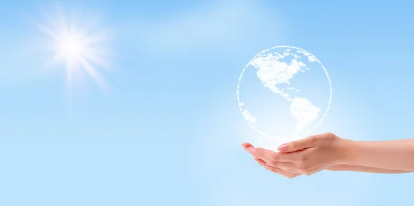 Ecology Concept : Hand holding white earth globe clouds shape with blue sky and sunlight in background.