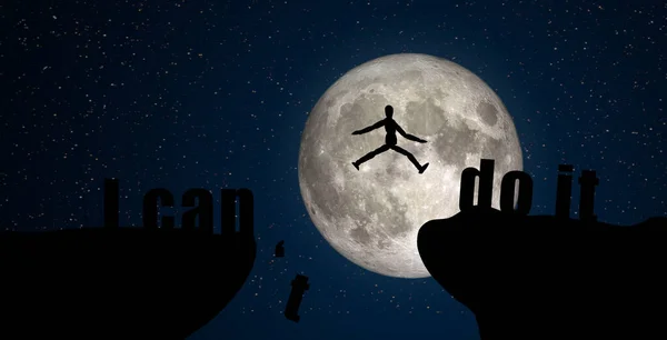 Business Success and Idea Concept : Silhouette of Wooden model toy jumping over cliff with full moon and night sky in background. (Elements of this image furnished by NASA.)