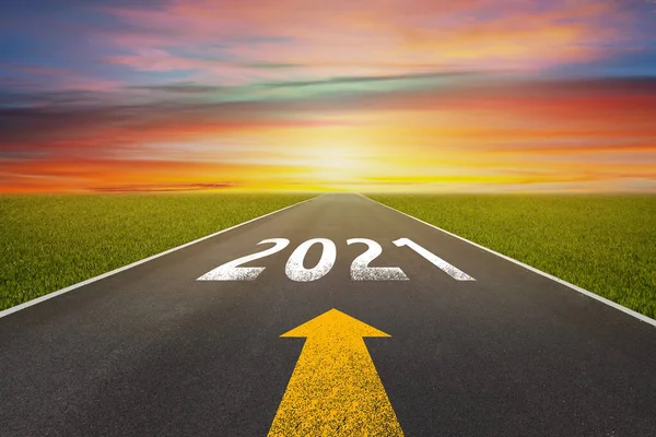 New Year 2021 Concept : Empty asphalt street road and writing text 2021 on roadway.