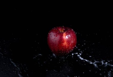 siyah arka plan üzerinde kırmızı elma sıçrama