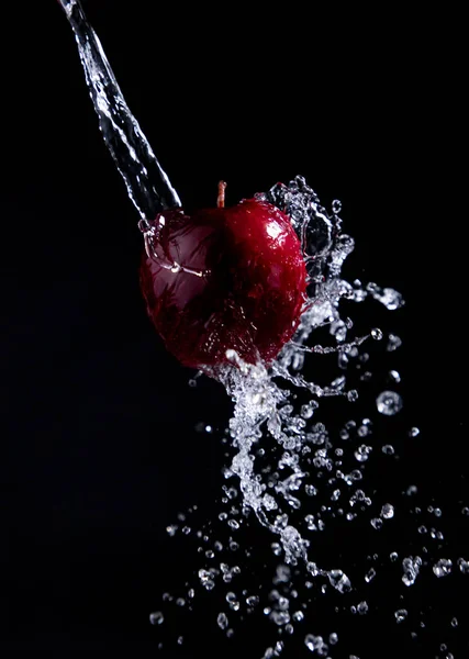 red apple splash on black background