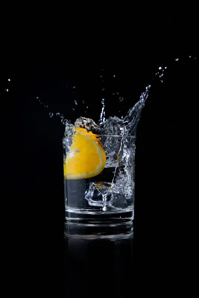 Orange Slice Falling Glass Water Royalty Free Stock Photos