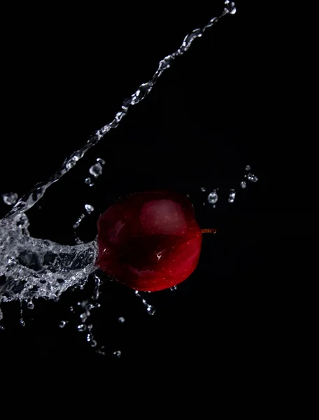 red apple splash on black background