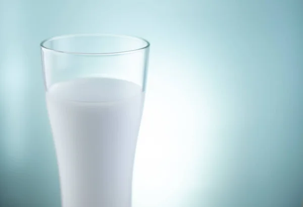 glass of milk on background