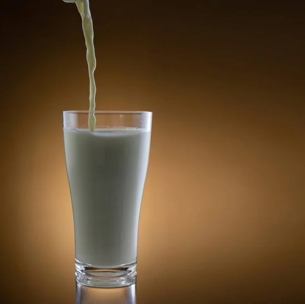 pouring milk on background