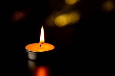 burning candle on dark background clipart