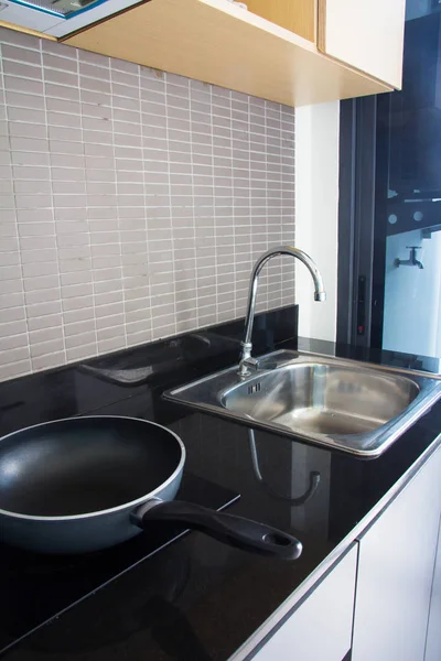 Water tap with sink in modern kitchen.