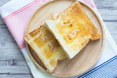 Ahşap bir tabakta tereyağı ile Tost