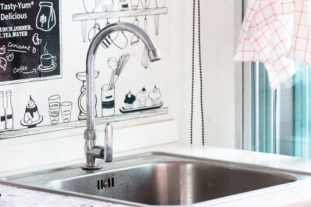 Water tap with sink in modern kitchen