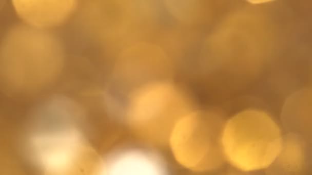 Abstract Gold bokeh lights in motion in 4k video. High quality render of gold particles. Ideal for Christmas, valentines day, wedding, love, celebration and party videos as background — Stock Video