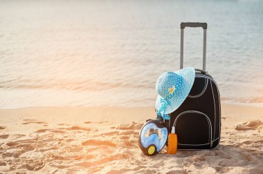 Bavul ve şapka, güneş kremi maskesi. Tropikal deniz, plaj içinde belgili tanımlık geçmiş. Yaz eğlence kavramı seyahat ve trafik cruise