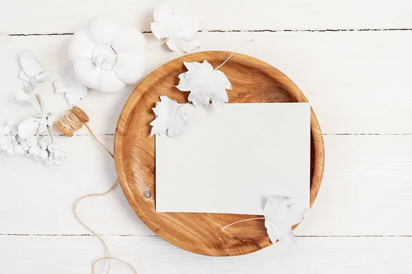 Vit trä bakgrund. Trä plats med vita pappersark. Vit pumpa, bär och blad på en mockup höst gratulationskort för Thanksgiving Day i rustik stil med utrymme för din text. Platt — Stockfoto