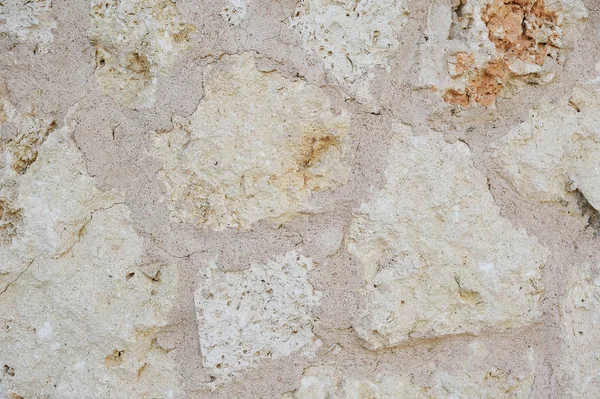Textuur muur fragment met krassen en scheuren stenen achtergrond — Stockfoto