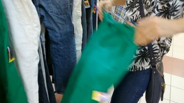Kiev, Ukraina-maj 23 2019: klädaffär omklädningsrum. Kaukasiska ung kvinna väljer hennes mode outfit kläder i garderoben hemma eller butik — Stockvideo