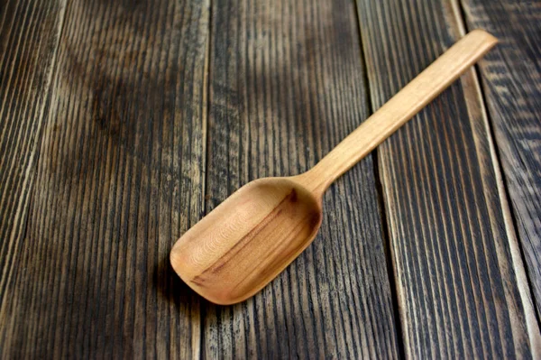 wooden spoon on wooden background