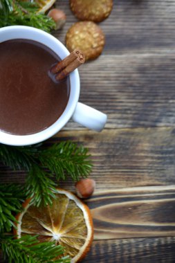 Sıcak çikolata veya kakao bir fincan ve köknar dallarında tarçın çubuğu ile. Kış soğuk hava için sıcak bir içecek. Yeni yıl ve Noel kavramı üstten görünüm