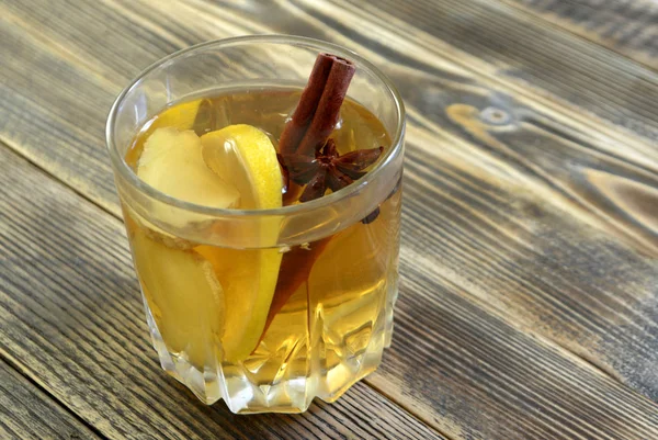 Ginger drink with lemon and spices Ginger tea on wooden table Copy space