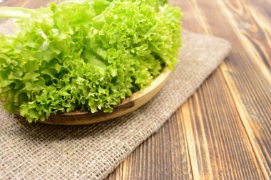 Ahşap kase sağlıklı gıda kavramı içinde taze organik yeşil marul salata yaprakları