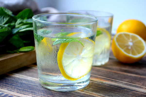 Cold refreshing lemonade with fresh mint and lemon in a glass Summer drink