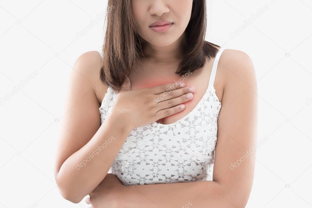 A woman suffering from heartburn on a gray background.