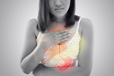 Woman suffering from Acid reflux or Heartburn. clipart