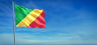 Kongo 'nun ulusal bayrağı açık mavi gökyüzünün önünde rüzgarda dalgalanıyor.