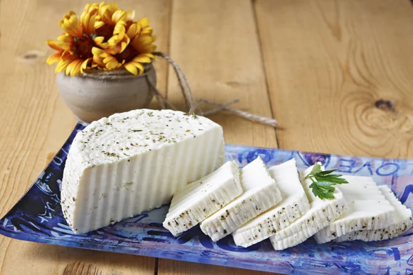 White cheese on a blue plate on a wooden background. — Stock Image White Cheese Blue Plate Wooden Background Royalty Free Stock Images