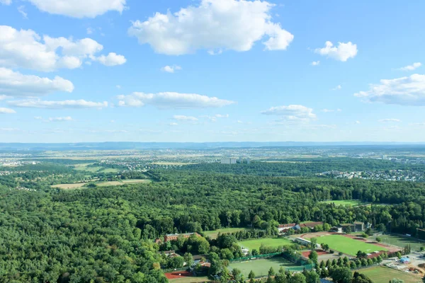 Amazing Landscape view on the beautiful forests, alpine mountains and idyllic fields of South Germany with a blue sky before sunset with clouds city view from the top