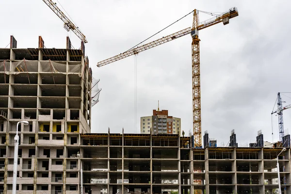 House under construction, monolithic construction, high crane