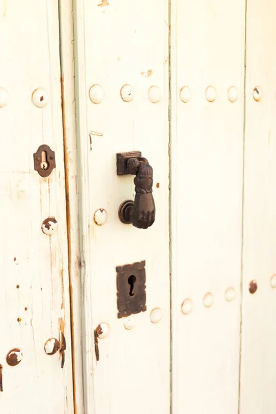 Close-up. Vintage handle for knocking on the door in the form of a hand