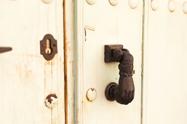 Close-up. Vintage handle for knocking on the door in the form of a hand