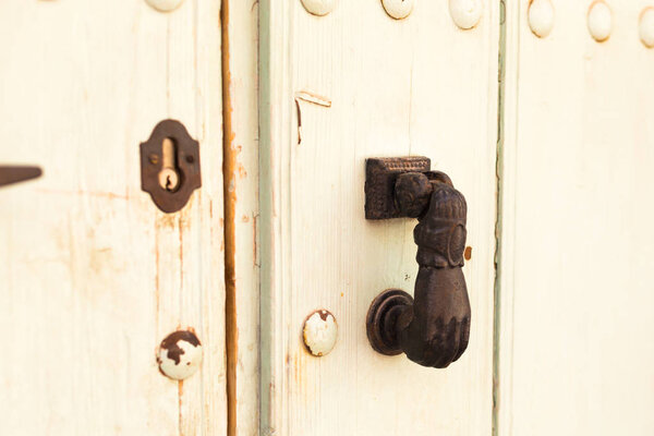 Close-up. Vintage handle for knocking on the door in the form of a hand
