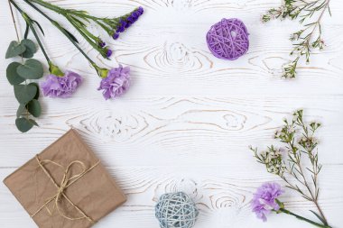 Kraft kağıt ve yukarıdan beyaz masada çiçek hediye veya mevcut kutusu sarılı. Düz styling yatıyordu. Metin için yer kopyalayın.