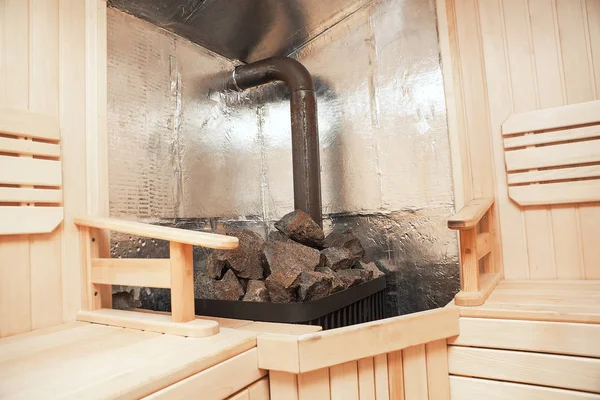 sauna interior with stove and hot stones