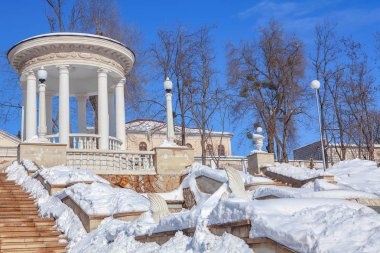 winter in urban park,white gazebo on the top