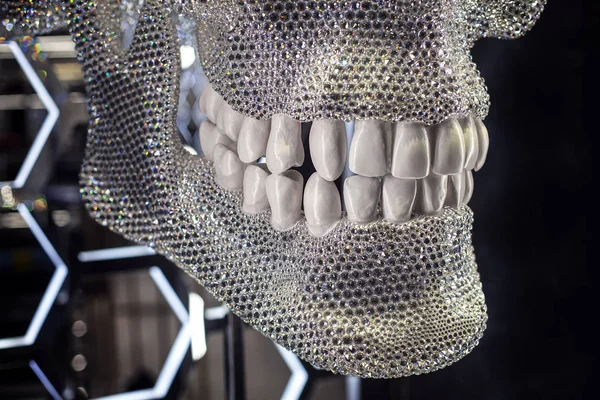 silver skull with white teeth