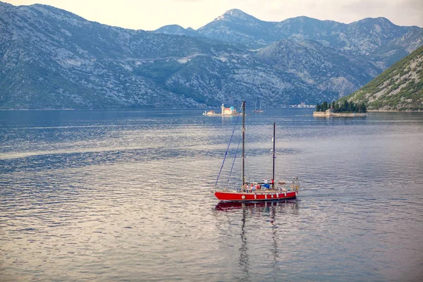 People sailing on modern yacht in Kotor Bay