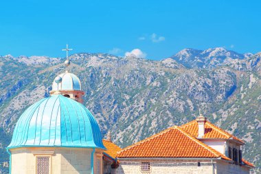 Mavi kilise kubbesi ve dağlara karşı fayanslı çatı Kotor Körfezi 'ndeki Kayalıkların Hanımefendisi. Manastır Çatısı Mimarisi Ayrıntıları 