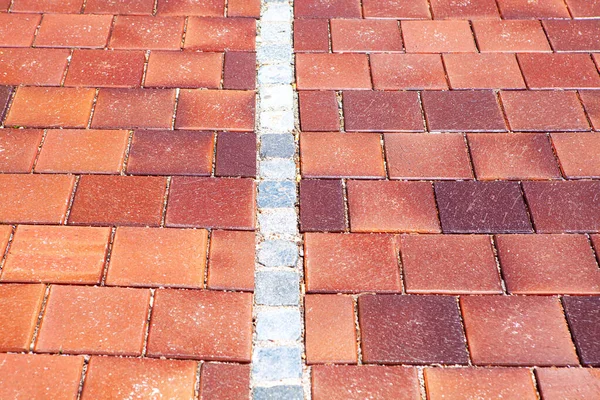 Brick road texture . Pavement made by red stone
