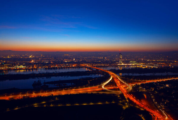 Aerial view of night Vienna . Illuminated Cityscape and Danube river in Wien