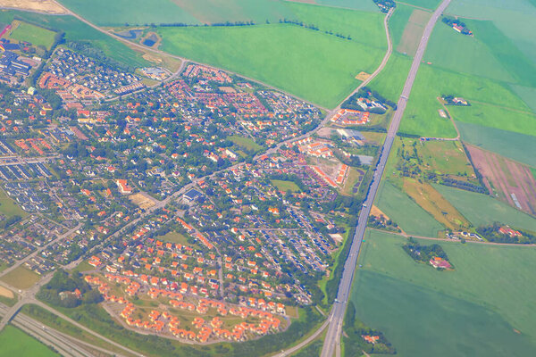 Aerial suburb view and green fields 