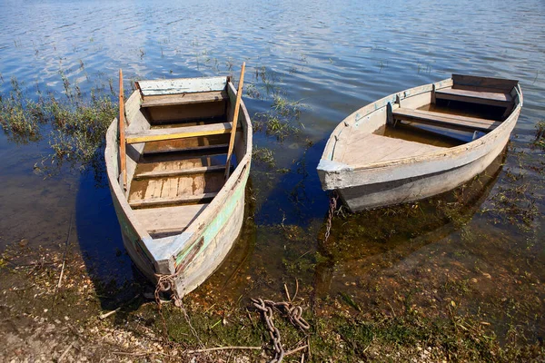 Moored old fishing wooden boats . Two vintage fishing boats in