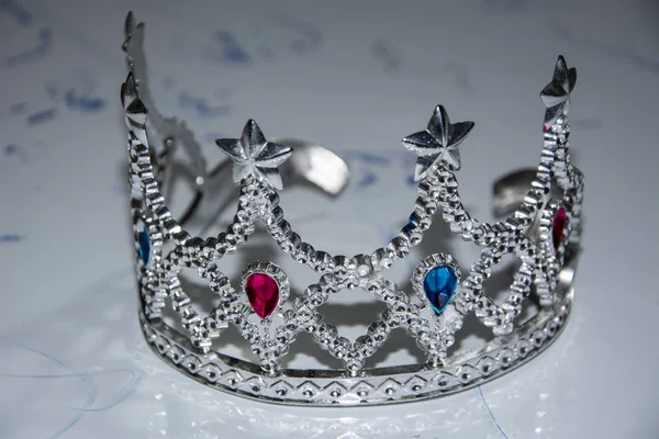Silver crown, close-up photo. White background.