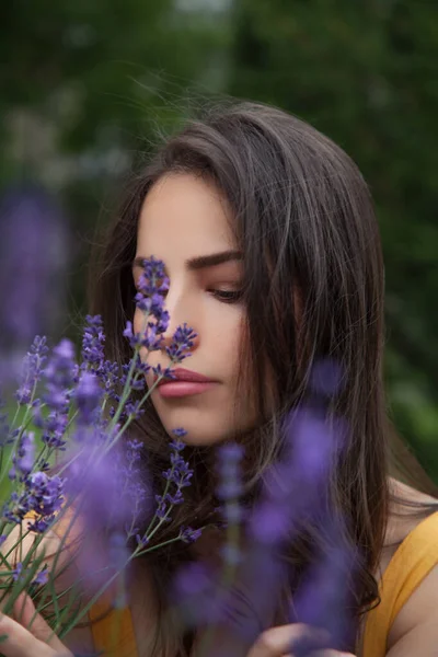 pretty young woman with lavender flower, natural beauty portrait