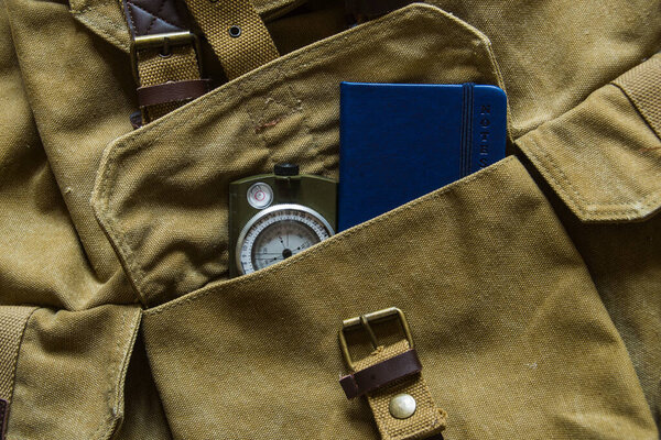 Ноутбук и компас в рюкзаке
